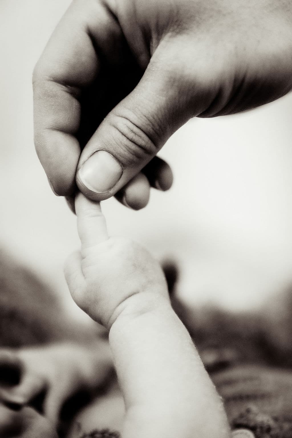 Baby gripping parent's hand