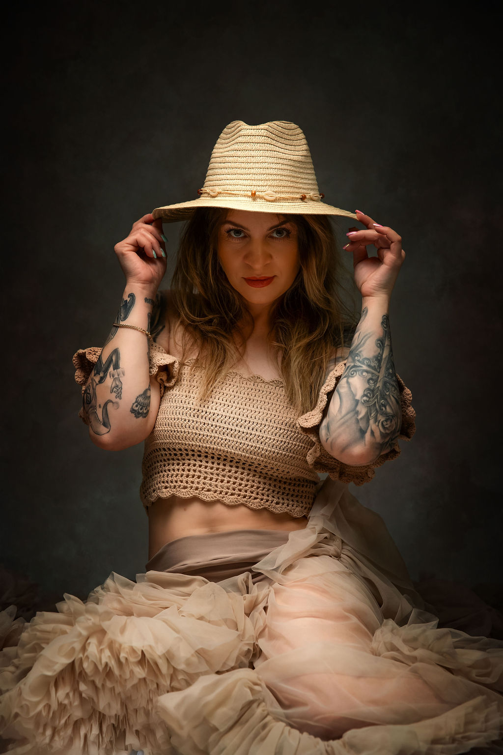 Glamour portrait with straw hat and tulle