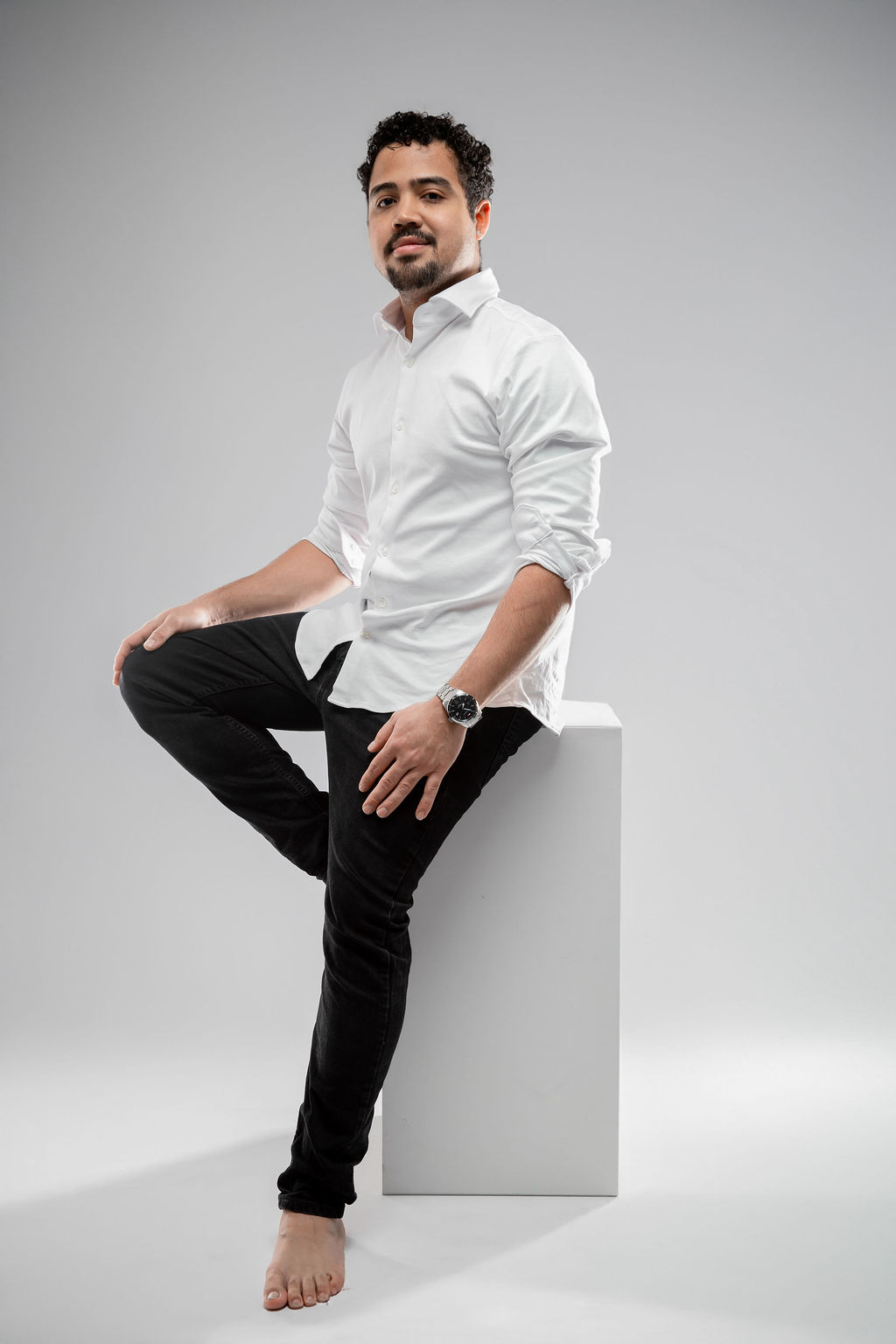 Studio portrait seated on cube